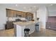 Modern kitchen with stainless steel appliances, granite countertops, a kitchen island, and barstool seating at 9035 Drummer Bay Ave, Las Vegas, NV 89149