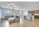 Open living space with a kitchen island, comfortable sectional couch, and ample natural light at 9035 Drummer Bay Ave, Las Vegas, NV 89149