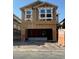 New construction home featuring a partially framed facade with modern windows and open garage space at 9082 Rivington Ave, Las Vegas, NV 89148