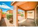 A charming covered back patio with serene desert landscaping and partial fencing for added privacy at 9271 Martel Ave, Las Vegas, NV 89148