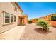 Backyard featuring desert landscaping, a covered patio, and a two-story home under a clear blue sky at 9271 Martel Ave, Las Vegas, NV 89148