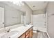 Bathroom with dual sinks, tub/shower and wood-look flooring at 9271 Martel Ave, Las Vegas, NV 89148