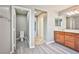 Ensuite bathroom featuring wood cabinets, double sinks and separate toilet room at 9271 Martel Ave, Las Vegas, NV 89148