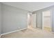 Bedroom featuring neutral carpet, light gray walls, and doors leading to additional spaces at 9271 Martel Ave, Las Vegas, NV 89148