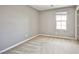 Bedroom featuring neutral carpet and light gray walls and a large window at 9271 Martel Ave, Las Vegas, NV 89148