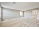 Bonus room with neutral carpet, light gray walls, and natural light, connected to upstairs hallway at 9271 Martel Ave, Las Vegas, NV 89148