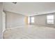 Large, open bonus room with neutral walls, carpeting, and abundant natural light at 9271 Martel Ave, Las Vegas, NV 89148