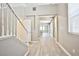 Bright foyer with staircase and light wood-style flooring leading into an open-concept living space at 9271 Martel Ave, Las Vegas, NV 89148