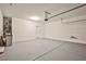 Bright garage with epoxy floors, utility connections, and ample space for vehicles at 9271 Martel Ave, Las Vegas, NV 89148
