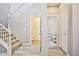 Well-lit hallway with carpeted stairs and doors to a closet and half-bathroom at 9271 Martel Ave, Las Vegas, NV 89148