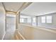 Hallway leading to a bright living space with natural light, light gray walls, and wood-style flooring at 9271 Martel Ave, Las Vegas, NV 89148