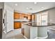 Kitchen with granite counters, stainless steel appliances, wood cabinetry and an island with seating at 9271 Martel Ave, Las Vegas, NV 89148