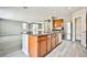 Kitchen featuring granite countertops, wood cabinetry and an island with a sink at 9271 Martel Ave, Las Vegas, NV 89148