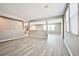 Open-concept living room with light wood flooring, gray walls and large windows providing natural light at 9271 Martel Ave, Las Vegas, NV 89148