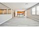 Spacious living room with hardwood floors leading to the modern kitchen and bright natural light at 9271 Martel Ave, Las Vegas, NV 89148