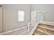 A staircase with white banister, carpeted steps, and a window providing natural light at 9271 Martel Ave, Las Vegas, NV 89148