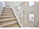 Carpeted staircase with white railing and natural light from windows at 9271 Martel Ave, Las Vegas, NV 89148