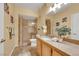 Bathroom features a walk-in shower, granite vanity, and decorative wall art at 10001 Peace Way # 1250, Las Vegas, NV 89147