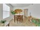 Bright dining area with a wooden table set next to a large window and a view of the open kitchen at 10001 Peace Way # 1250, Las Vegas, NV 89147