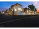 Charming two-story building with a two-car garage in a well-maintained community at dusk at 10001 Peace Way # 1250, Las Vegas, NV 89147