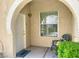 Inviting front porch with a decorative chair, plants and welcome mat by the front door at 10001 Peace Way # 1250, Las Vegas, NV 89147
