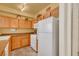 Bright kitchen with matching wooden cabinets, white appliances, and ample counter space at 10001 Peace Way # 1250, Las Vegas, NV 89147