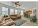 Cozy living room with neutral tile flooring leads to a bright dining area and an open kitchen at 10001 Peace Way # 1250, Las Vegas, NV 89147