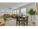 Open-concept living room featuring neutral tile flooring leading to dining area and a view of the kitchen at 10001 Peace Way # 1250, Las Vegas, NV 89147