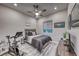 Cozy bedroom features modern decor, ceiling fan and views of the backyard at 101 Mirage View Dr, Henderson, NV 89011