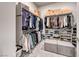Walk-in closet featuring shelving, hanging racks and two storage ottomans at 101 Mirage View Dr, Henderson, NV 89011