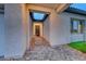 Close-up of the covered entryway featuring a stone paver walkway and stylish architectural details at 101 Mirage View Dr, Henderson, NV 89011