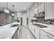 Modern kitchen featuring stainless steel hood and appliances, sleek countertops, and tile backsplash at 101 Mirage View Dr, Henderson, NV 89011