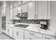 Kitchen with stainless steel appliances, quartz countertops, and white cabinets at 101 Mirage View Dr, Henderson, NV 89011