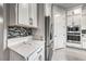 Close-up of kitchen featuring modern appliances, countertops, and custom tile backsplash at 101 Mirage View Dr, Henderson, NV 89011