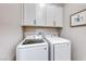 Laundry room featuring side-by-side washer and dryer and overhead cabinets at 101 Mirage View Dr, Henderson, NV 89011