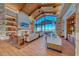 Charming lounge area showcasing wood floors, stone fireplace, comfortable seating and large windows with desert views at 101 Mirage View Dr, Henderson, NV 89011