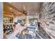 Covered outdoor kitchen with stone backsplash and large sink near a relaxing outdoor patio at 101 Mirage View Dr, Henderson, NV 89011