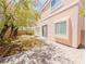 Charming backyard with a brick patio, small grassy area, and secure fencing at 10469 Mulvaney Cir, Las Vegas, NV 89141