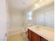 Bathroom featuring a shower-tub combo and large mirror above sink at 10469 Mulvaney Cir, Las Vegas, NV 89141