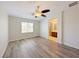 Neutral paint and light hardwood floors highlight this bedroom with an ensuite bath at 10469 Mulvaney Cir, Las Vegas, NV 89141