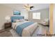 Bright bedroom featuring hardwood floors, a ceiling fan, and a large window for natural light at 10469 Mulvaney Cir, Las Vegas, NV 89141