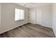A naturally lit bedroom with hardwood floors and floating shelves at 10469 Mulvaney Cir, Las Vegas, NV 89141