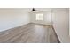 Spacious bedroom featuring wood-look flooring and multiple windows at 10469 Mulvaney Cir, Las Vegas, NV 89141