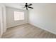 Bedroom with hardwood floors, a ceiling fan and natural lighting at 10469 Mulvaney Cir, Las Vegas, NV 89141