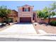 Charming two-story home with a well-maintained front yard and a two car garage at 10469 Mulvaney Cir, Las Vegas, NV 89141