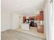 Kitchen with wood cabinets, an island, granite counters and backyard access at 10469 Mulvaney Cir, Las Vegas, NV 89141