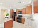 Kitchen features granite countertops, tile floor, wooden cabinets, and black appliances at 10469 Mulvaney Cir, Las Vegas, NV 89141