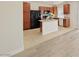 Charming kitchen with wood cabinets, an island, granite counters and stainless steel appliances at 10469 Mulvaney Cir, Las Vegas, NV 89141