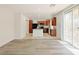 Bright, open kitchen featuring wood cabinets, an island, granite counters and backyard access at 10469 Mulvaney Cir, Las Vegas, NV 89141