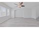 Bright and airy living room with wood floors, large windows, and a calming neutral color palette at 10469 Mulvaney Cir, Las Vegas, NV 89141